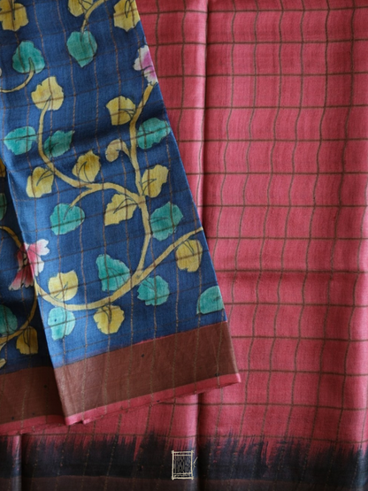 Coral pink check blouse piece folded over indigo kalamkari pallu with shibori ombré edge