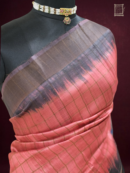 Top bust shot of coral tussar saree with hand-dyed shibori-style black ombré border