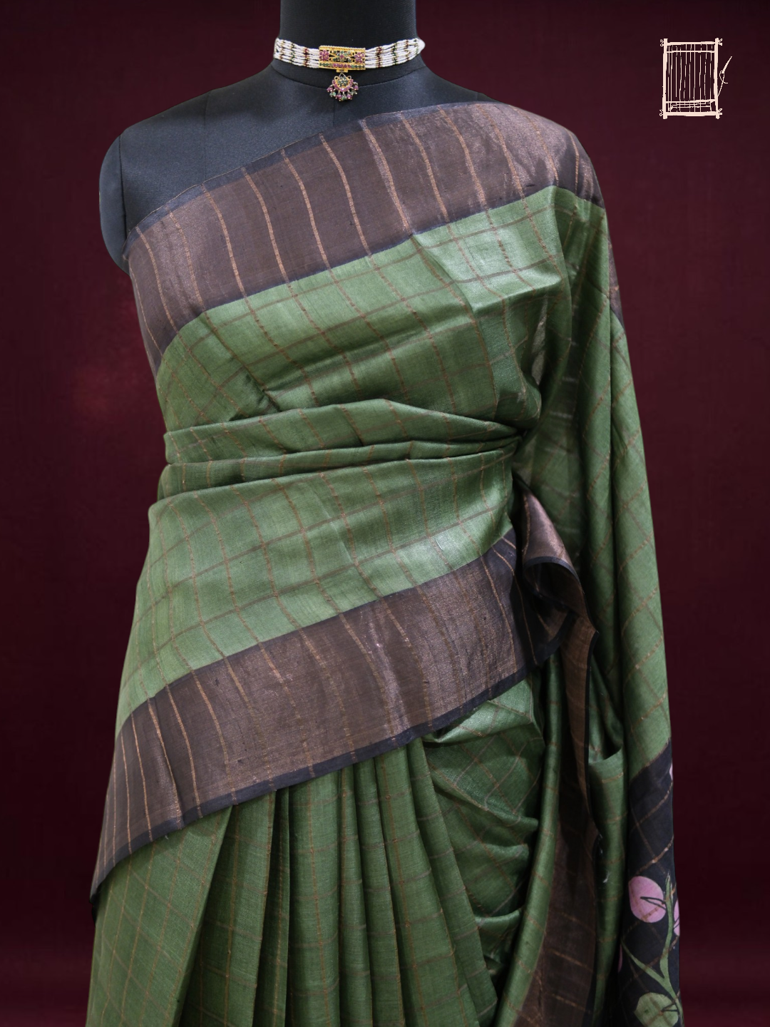 Half-body drape of forest green tussar saree showing copper-zari checks and charcoal border