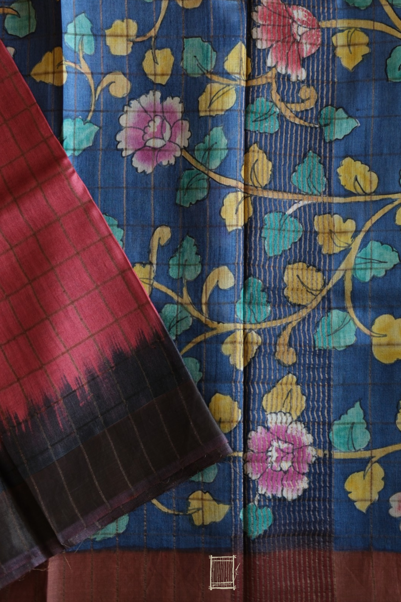Indigo kalamkari pallu with rose, yellow and teal florals beside coral tussar body