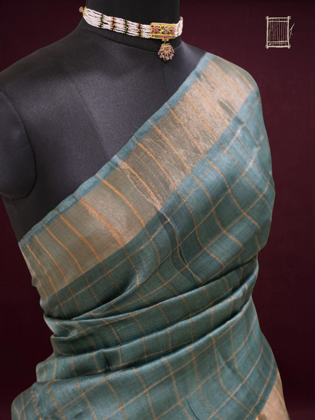 Top bust drape of teal tussar saree with fine gold zari check border